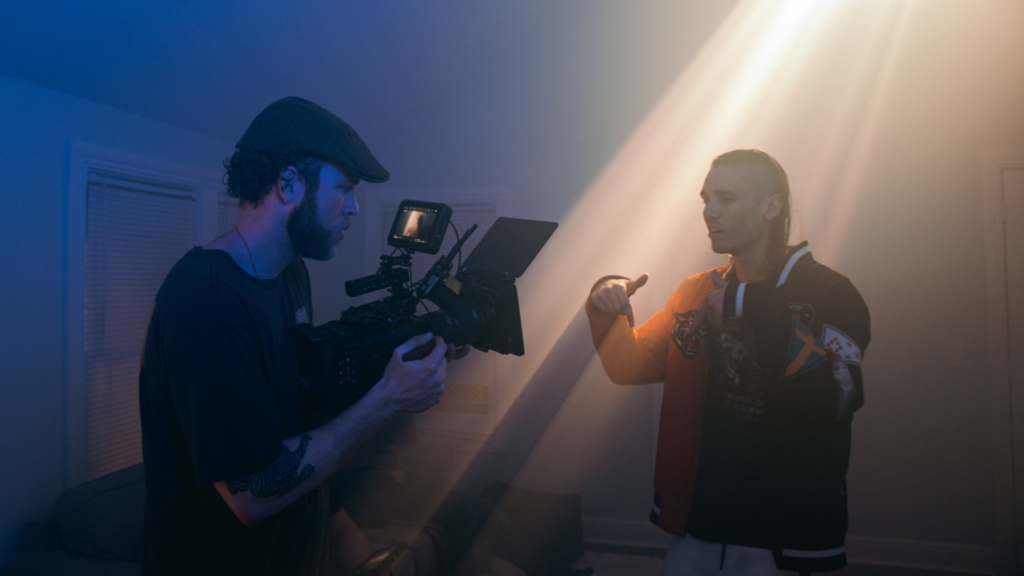 Videographer filming a rapper in a dramatic light setup