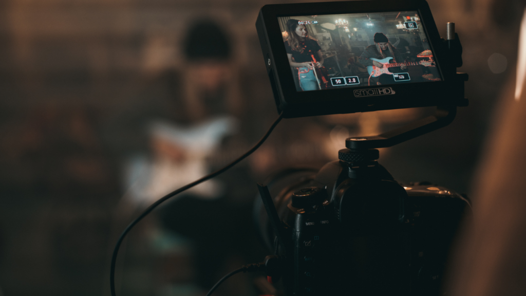 Camera monitor showing musicians performing with guitars